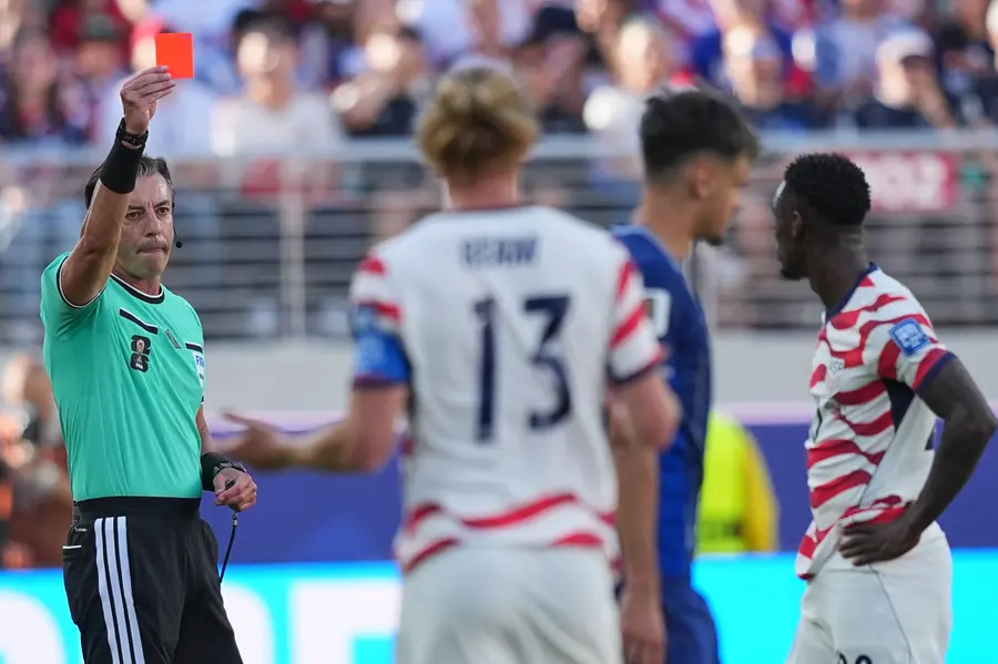 Referee Raphael Claus of Brazil shows a red card to United States' Folarin Balogun, right, during the World Cup round of 32 soccer match between the United States and Bosnia | PTI