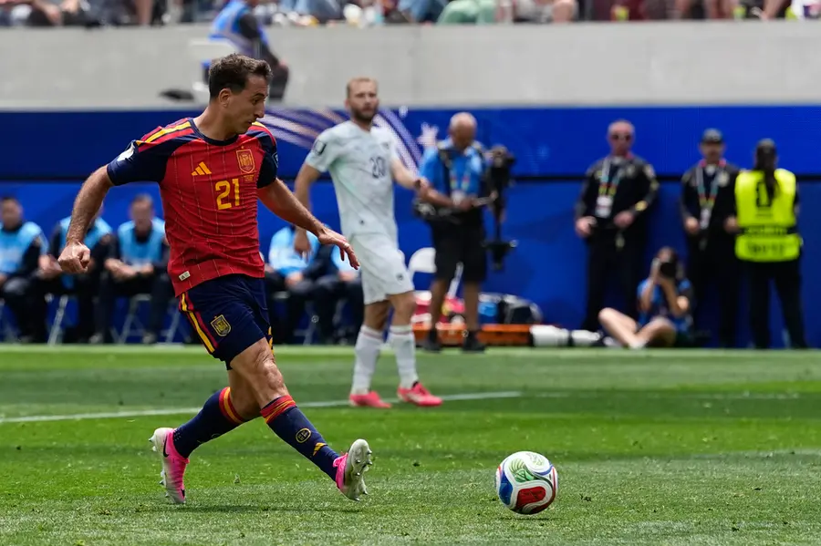 Spain's Mikel Oyarzabal (21) scores their third goal during the World Cup round of 32 soccer match between Spain and Austria