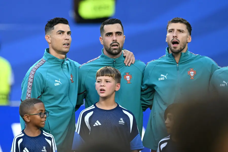 Portugal's forward Cristiano Ronaldo, goalkeeper Diogo Costa, and defender Ruben Dias sing their national anthem | AFP