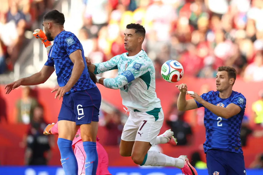 Cristiano Ronaldo, Croatia's defenders Josip Sutalo and  Josip Stanisic fight for the ball