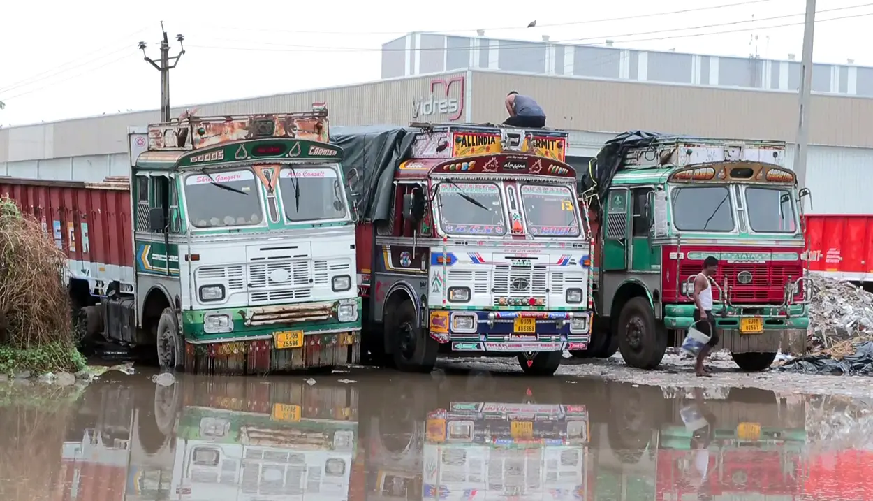 Vehicles stand at the waterlogged area due to heavy rain, in Mehsana on Friday. (ANI Video Grab)