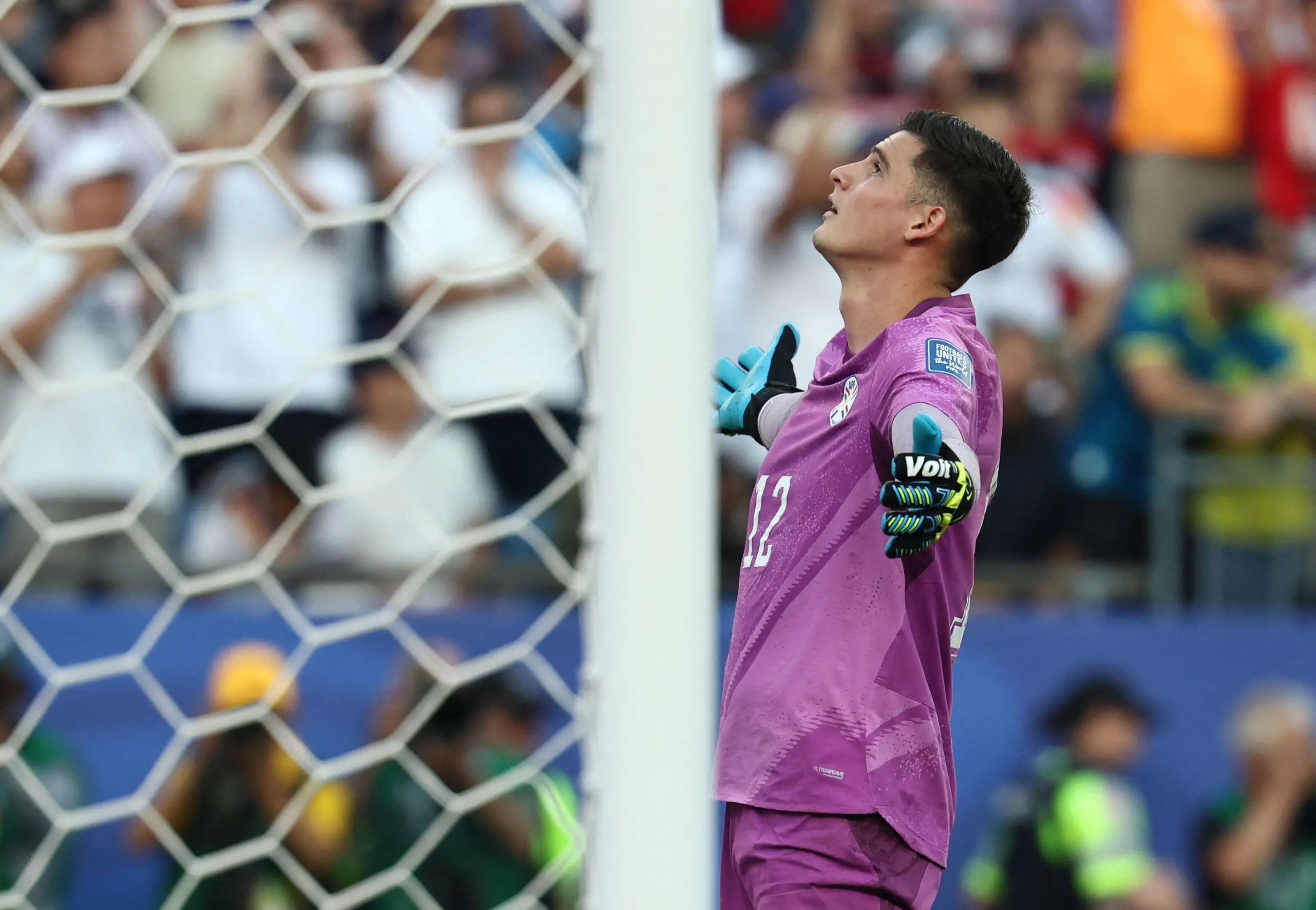 Paraguay's goalkeeper Orlando Gill (L) reacts after saving a penalty by Germany's forward Nick Woltemade | AFP