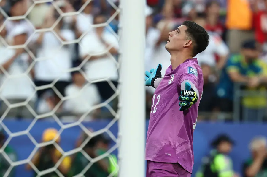 Paraguay's goalkeeper Orlando Gill (L) reacts after saving a penalty by Germany's forward Nick Woltemade