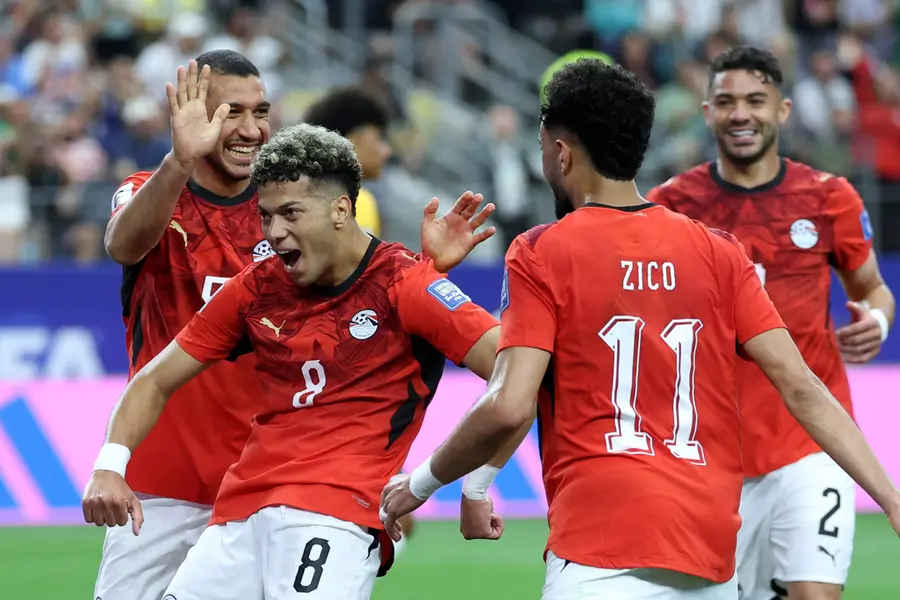 Egypt's midfielder Emam Ashour (L) celebrates with teammates after scoring the opening goal