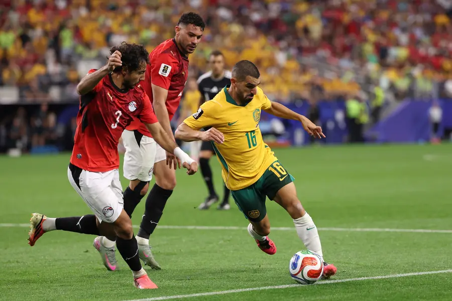 Australia's Aziz Behich (16) challenges for the ball with Egypt's Mohamed Hany (3) during the World Cup round of 32 soccer match