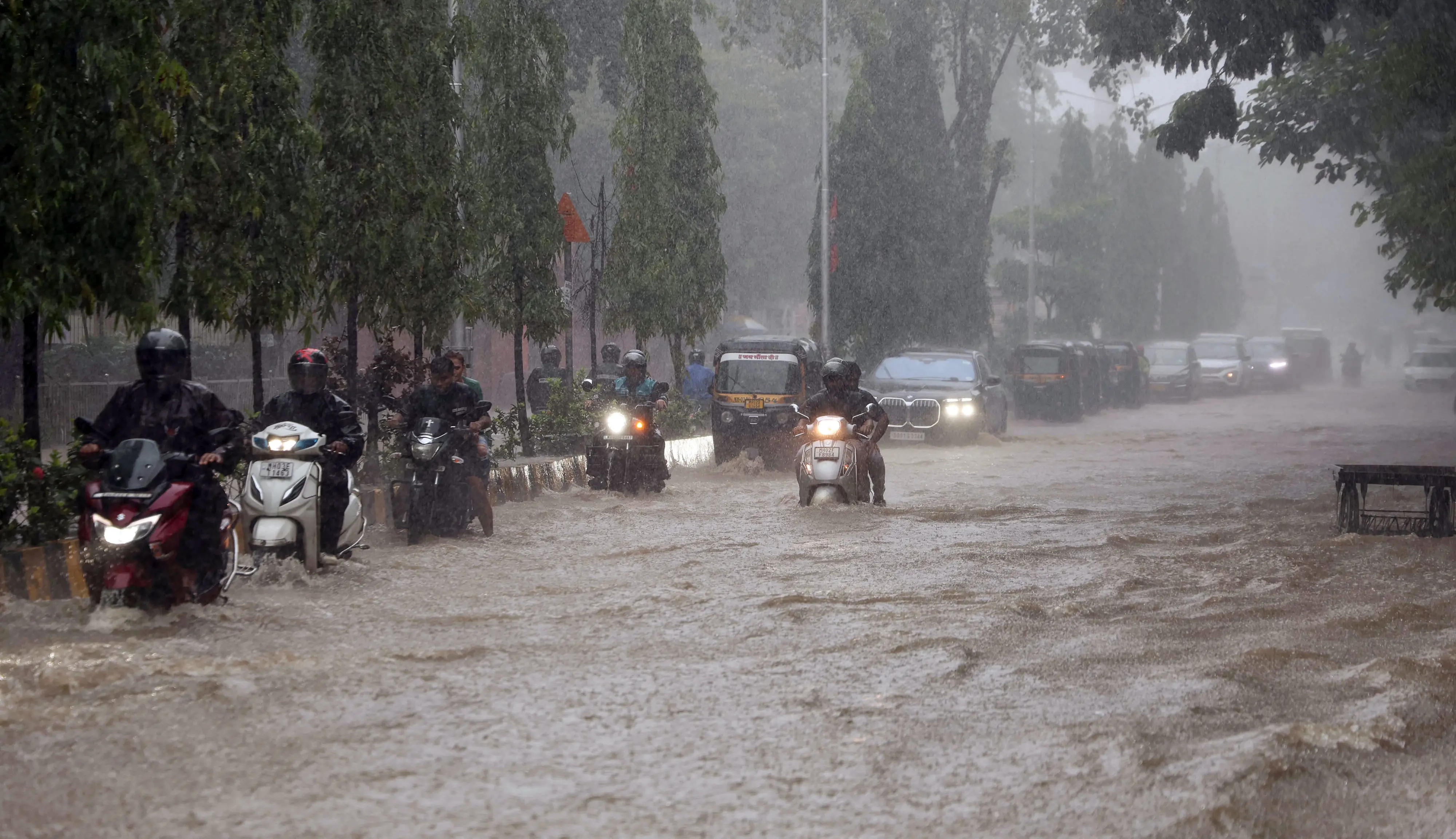 Vehicles wade through a waterlogged road at Andheri West
