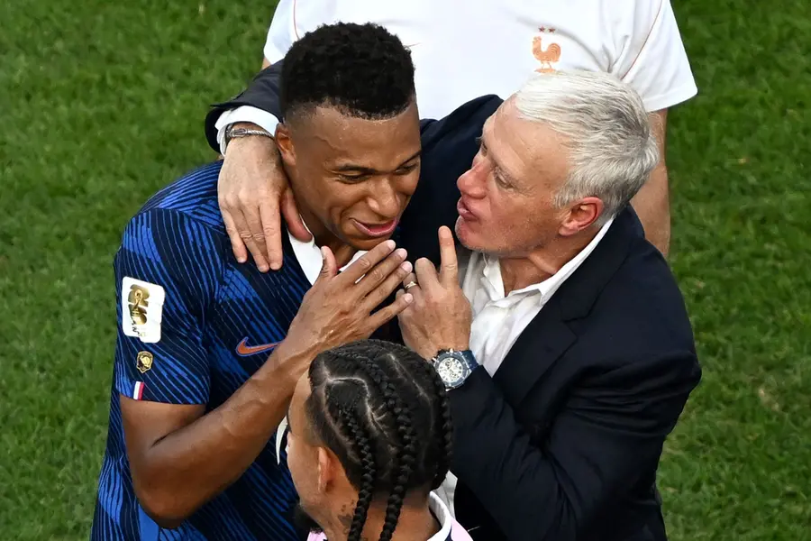 Kylian Mbappe celebrates with his coach Didier Deschamps after winning the 2026 World Cup round of 16 football match