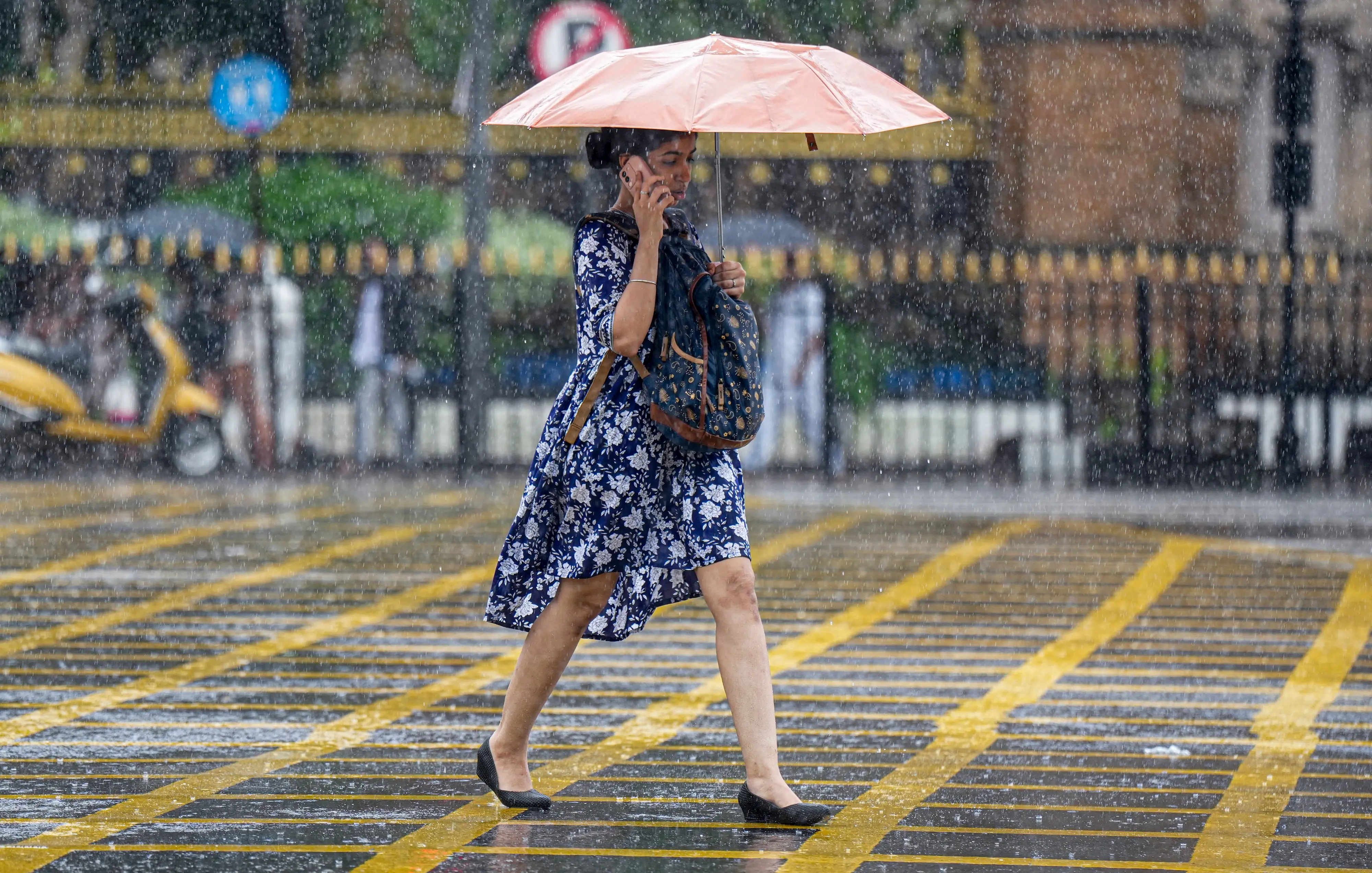 A woman walks amid rain in Mumbai | PTI