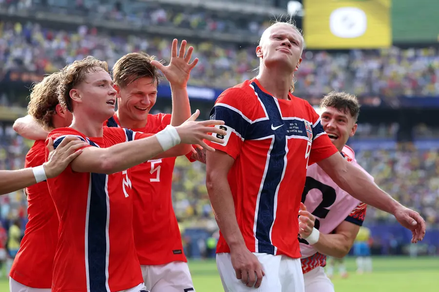Erling Haaland of Norway celebrates with teammates after scoring his team's second goal
