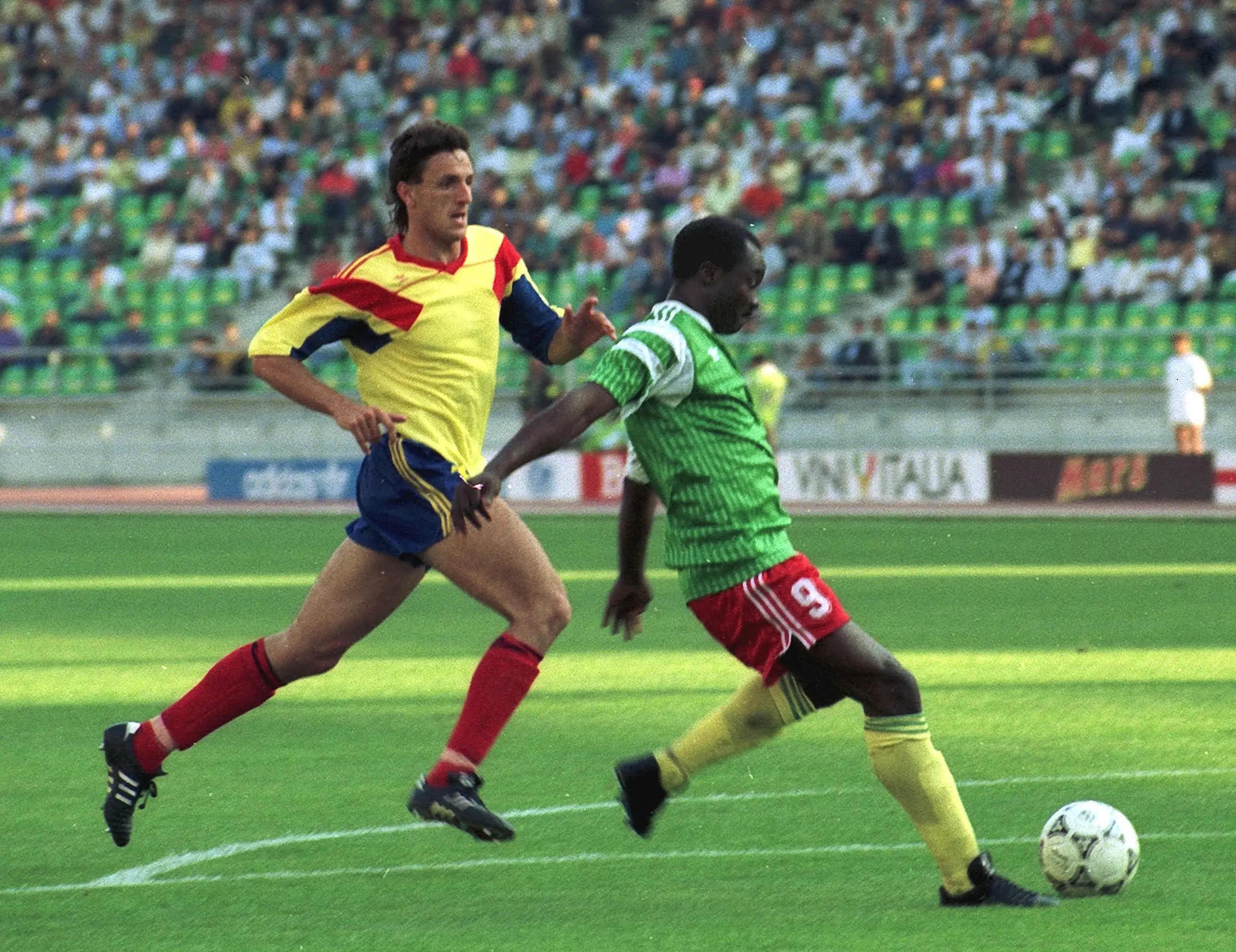 Roger Milla, right, being about to score the first of his two goals against Romania | AP