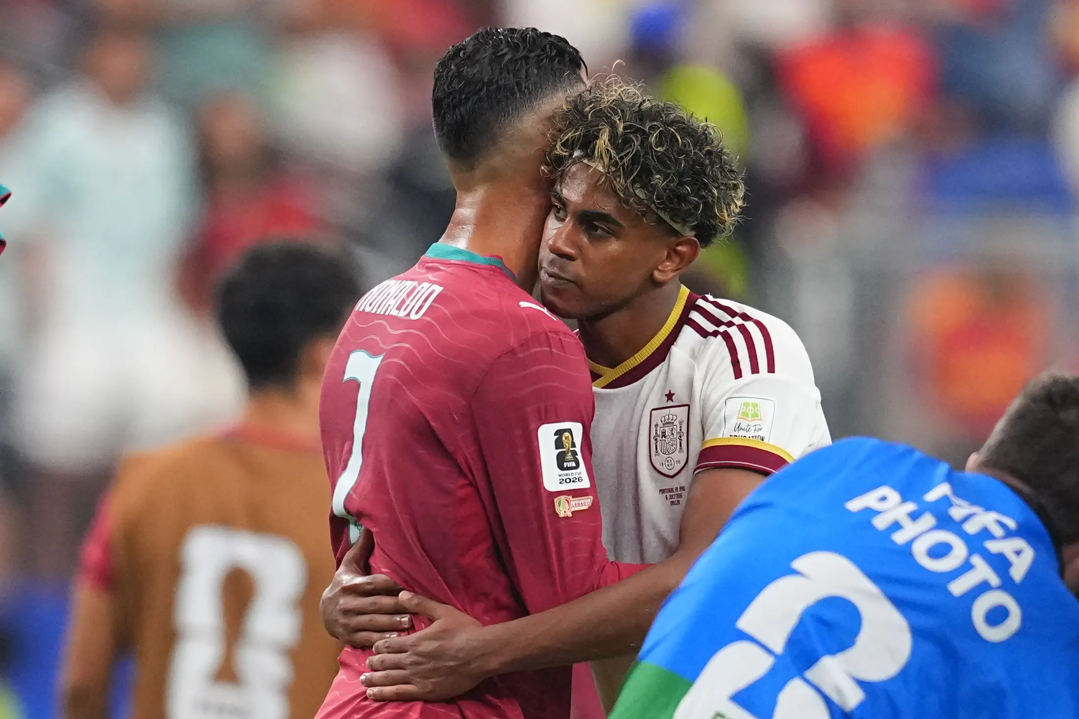 Spain's Lamine Yamal, right, hugs Portugal's Cristiano Ronaldo after the World Cup round of 16 soccer match between Portugal and Spain | AP