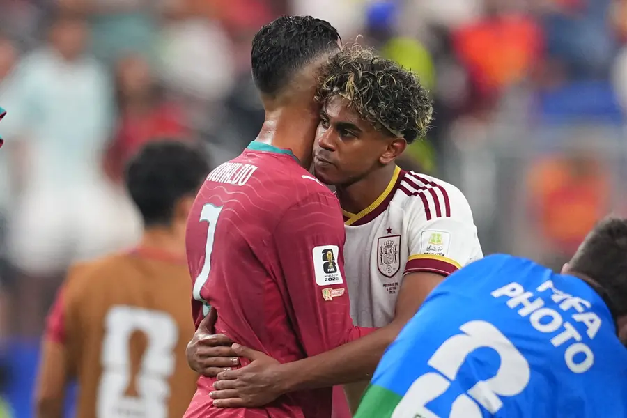 Spain's Lamine Yamal, right, hugs Portugal's Cristiano Ronaldo