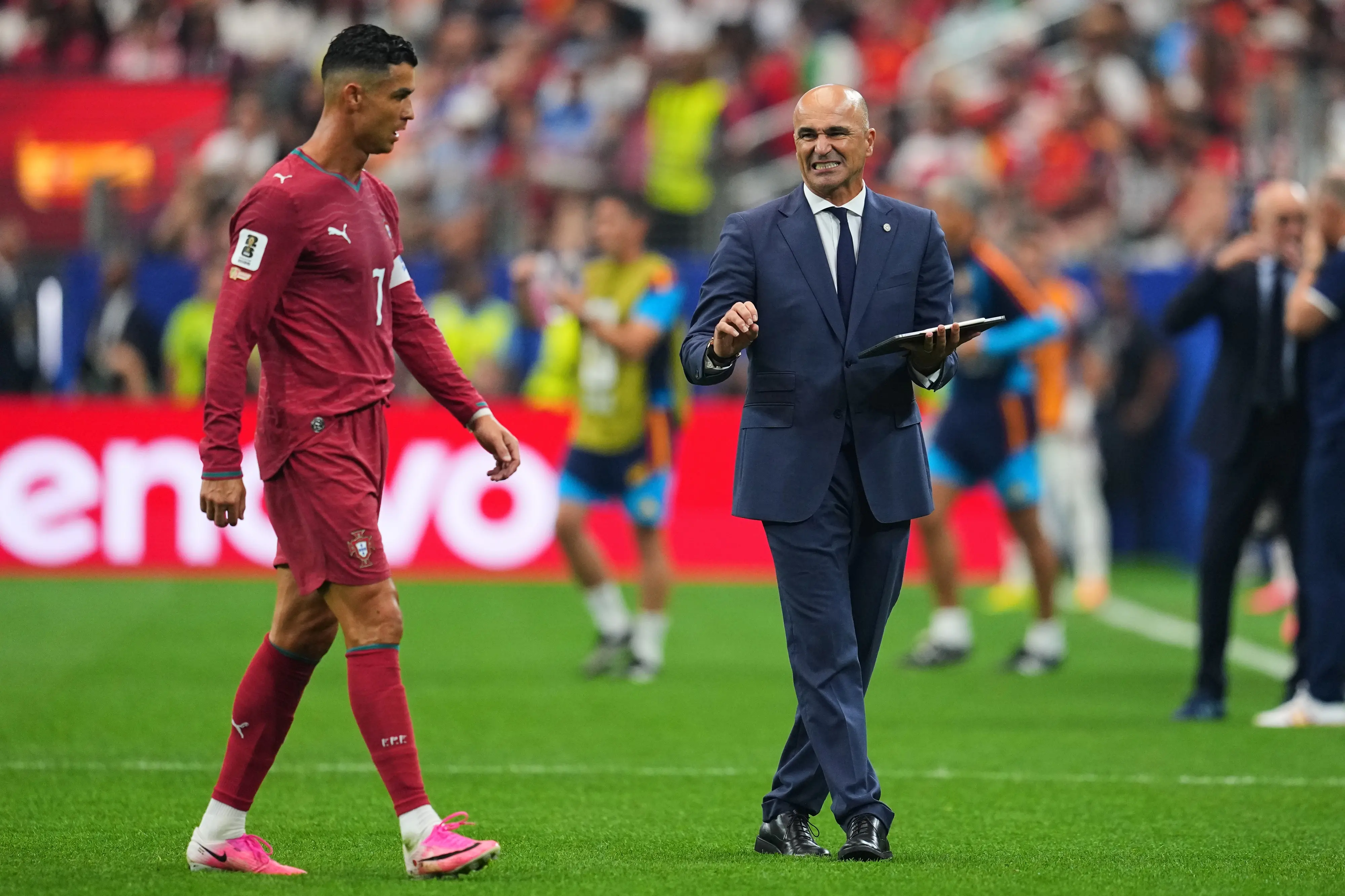 Portugal head coach Roberto Martinez, right, gives instructions to Cristiano Ronaldo (7) during the World Cup round of 16 soccer match | AP