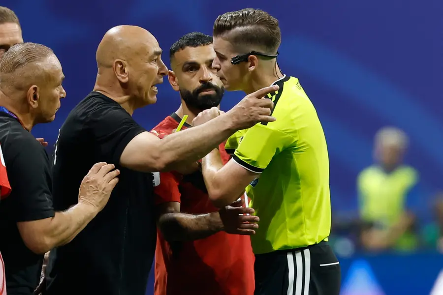Egypt head coach Hossam Hassan argues with referee