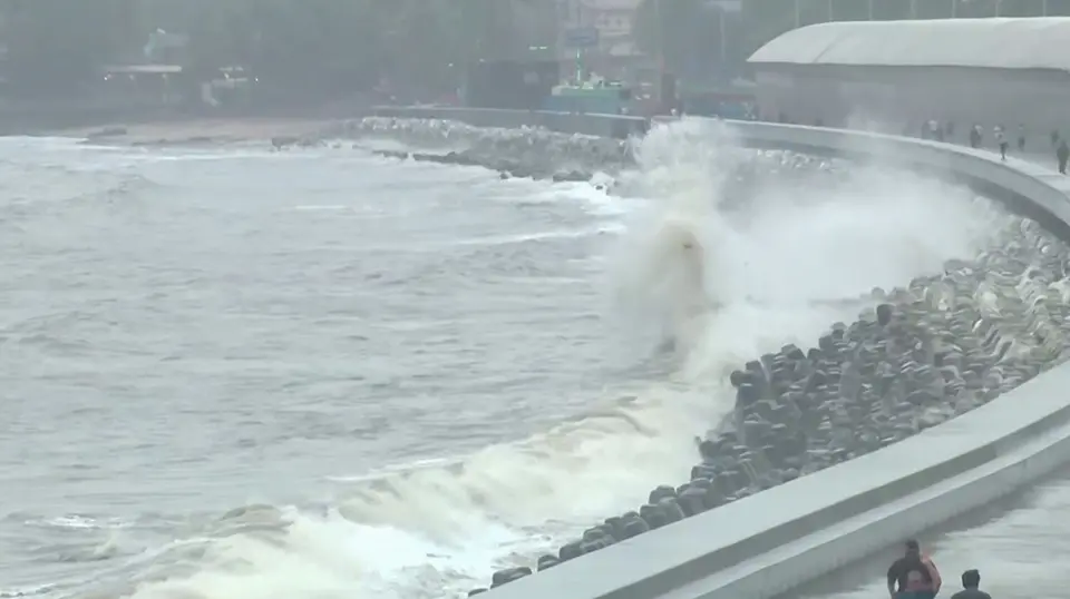 A view of an aggressive wave crashing from the Arabian Sea at Marine Drive amid heavy rainfall