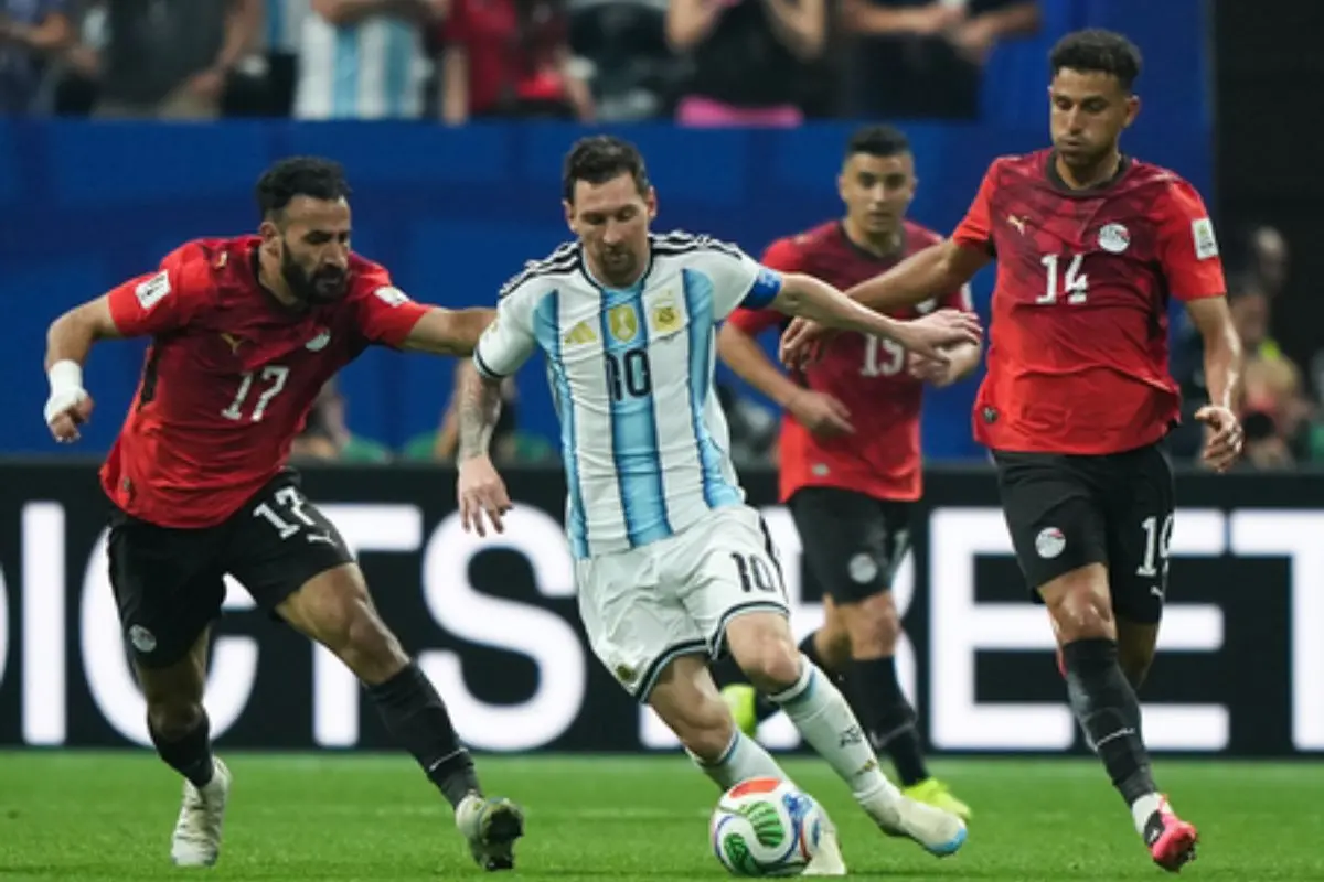 Lionel Messi being challenged by Egyptian defenders during Argentina's dramatic 3-2 comeback victory in the FIFA World Cup Round of 16. (Photo: IANS)