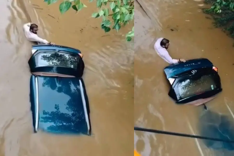 വെള്ളത്തിൽ മുങ്ങിപ്പോയ കാർ, കഴുത്തൊപ്പം വെള്ളത്തിൽ ഒഴുകിപ്പോകാതെ പിടിച്ച് ഉടമ| Video