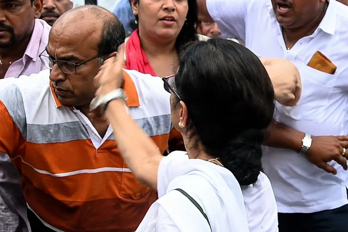 Mamata Banerjee gestures amid the chaos at a Kalighat protest rally, where a viral video appears to show her slapping a party worker.