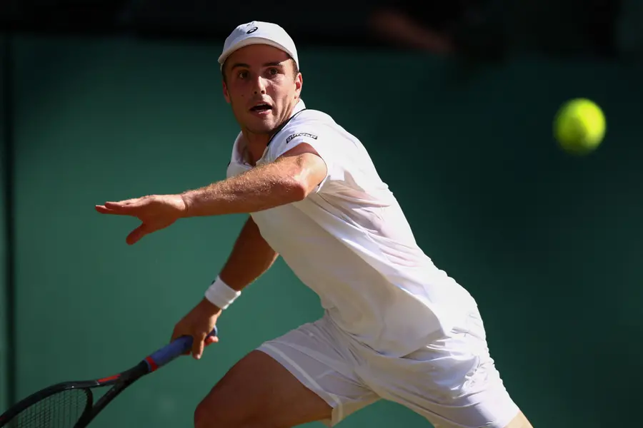 Britain's Arthur Fery returns to Italy's Flavio Cobolli during their men's singles quarter-final tennis match on the tenth day of the 2026 Wimbledon Championships | AFP