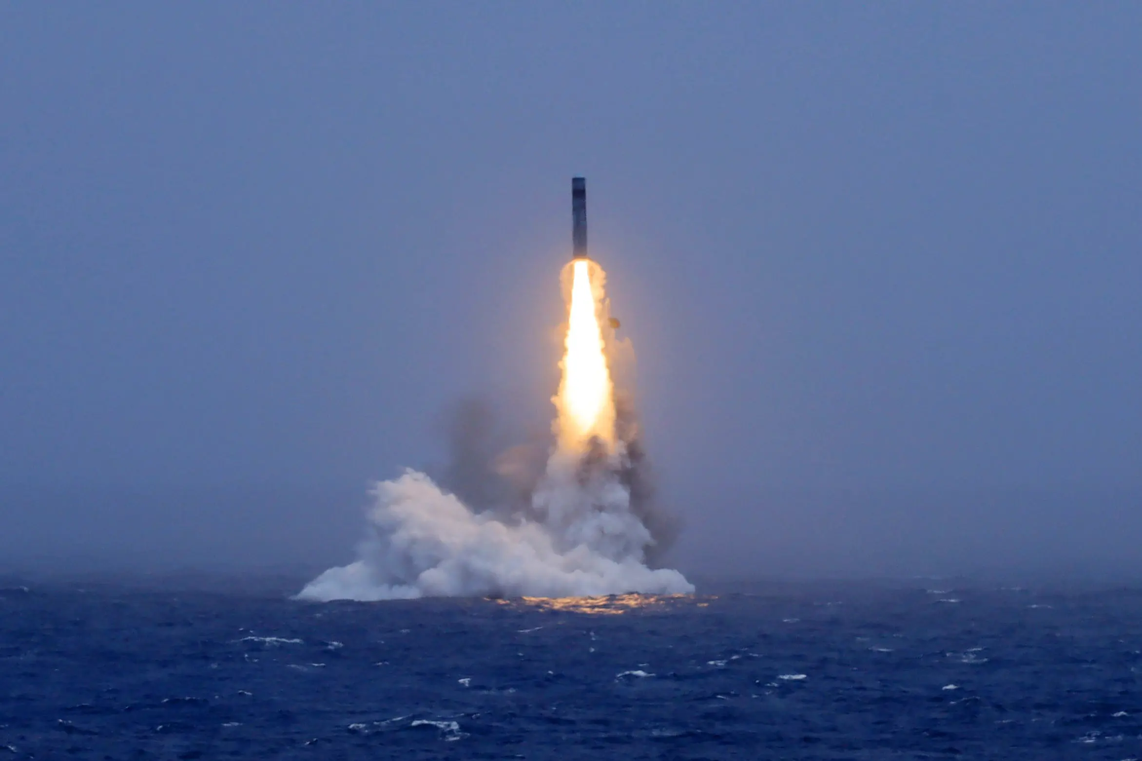 A long-range ballistic missile bursts out of the sea during a test launch from a Chinese nuclear-powered submarine in the South Pacific | Xinhua via AP