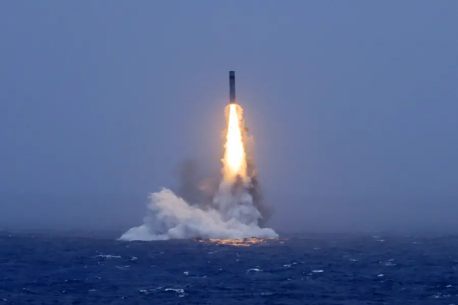 A long-range ballistic missile bursts out of the sea during a test launch from a Chinese nuclear-powered submarine in the South Pacific