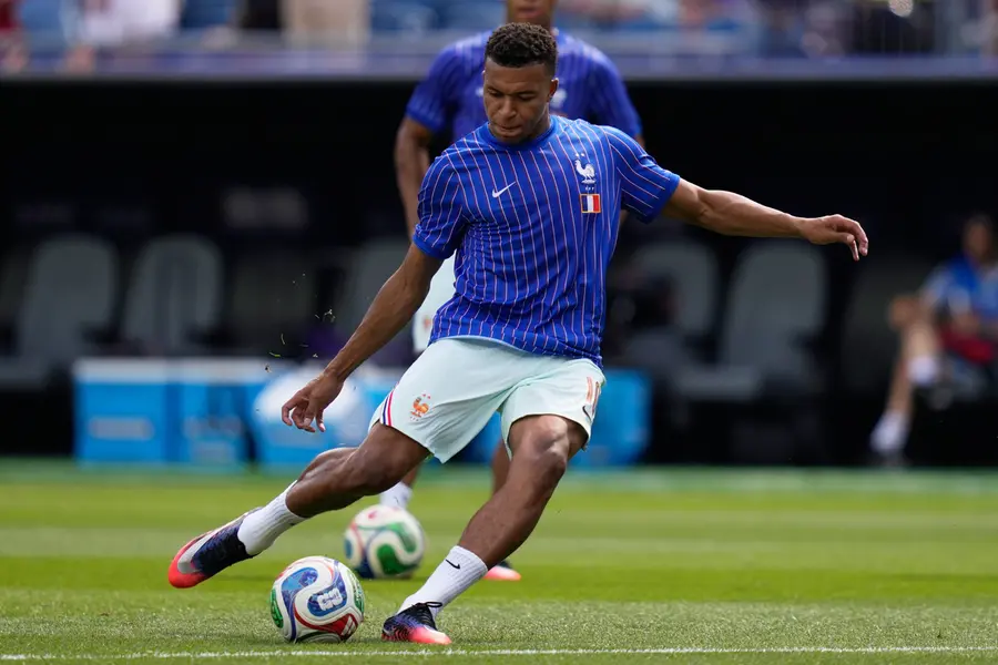 France's Kylian Mbappe warms up before the World Cup quarterfinal soccer match between France and Morocco