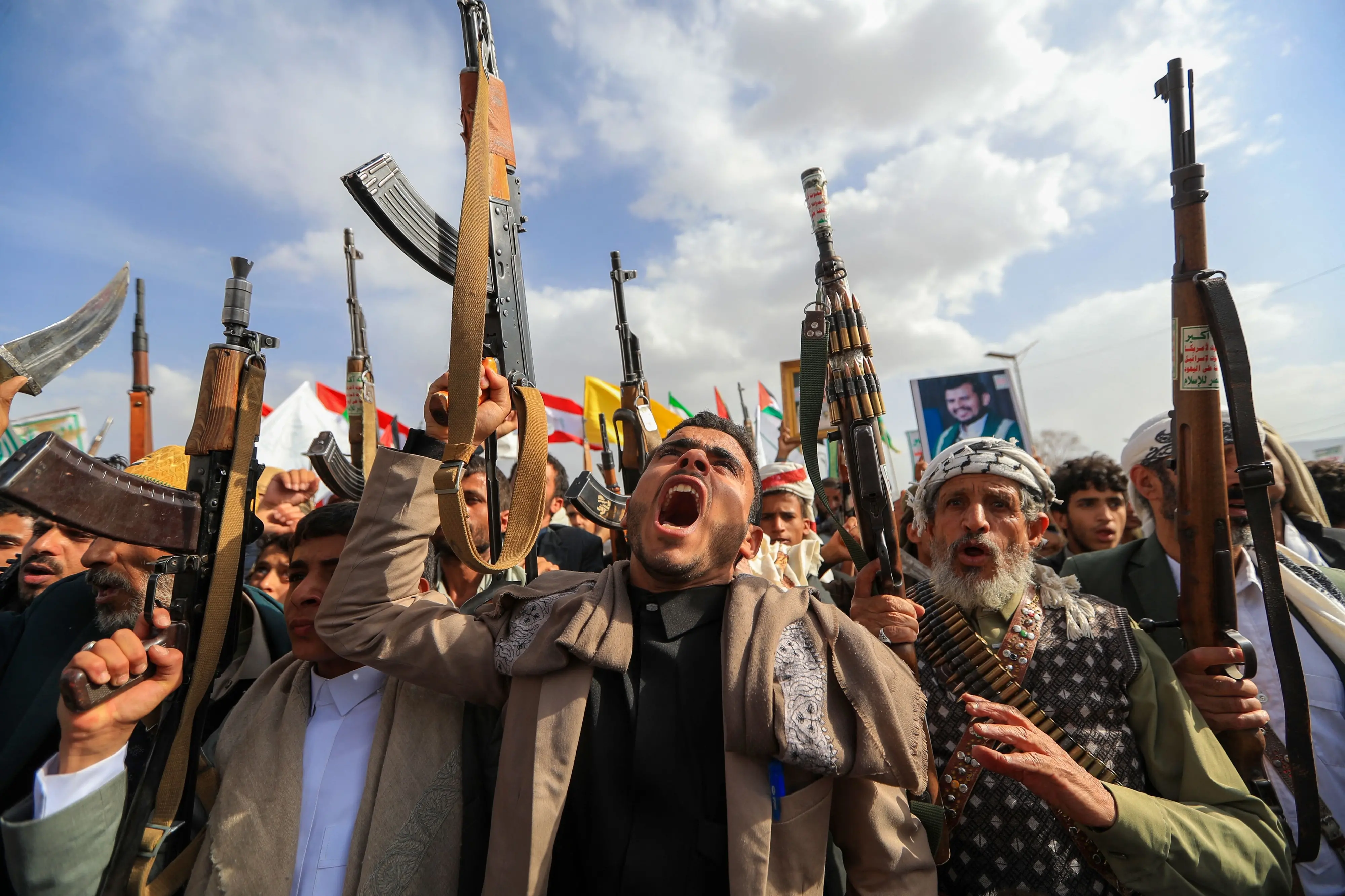 Armed Yemeni supporters of the Iran-backed Houthi movement brandish their weapons during a protest against US strikes on Iran | AFP
