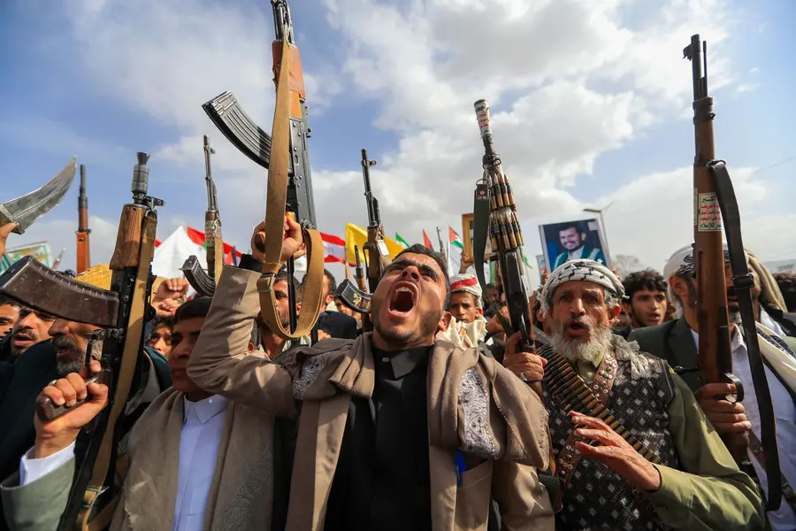 Armed Yemeni supporters of the Iran-backed Houthi movement brandish their weapons during a protest against US strikes on Iran