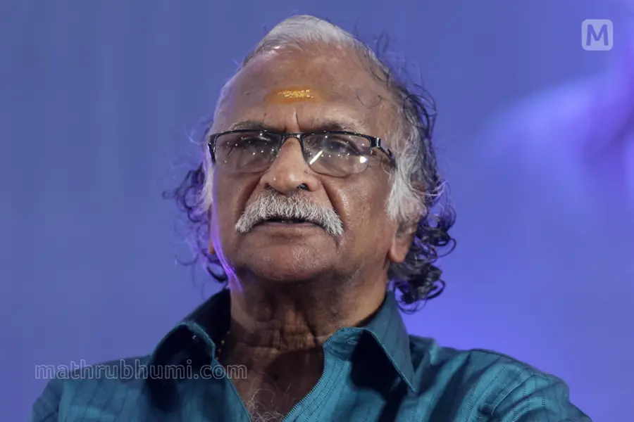 Sreekumaran Thampi holding Bimal Mitra's book 'Kori Diye Kinlam' while indirectly criticizing the Dileep court verdict