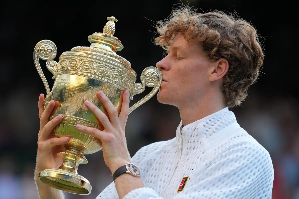 Jannik Sinner of Italy kisses the winners trophy after defeating Alexander Zverev of Germany in the men's singles final at Wimbledon Tennis Championships in London | Photo: AP