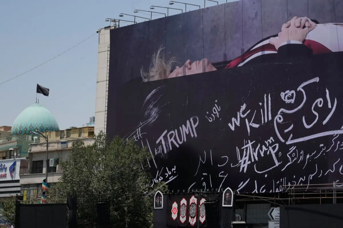 A billboard depicting U.S. President Donald Trump lying on what appears to be a coffin and bearing anti-Trump messages, including the phrase "We Kill Trump," is seen at Islamic Revolution Square in downtown Tehran, Iran, Wednesday, July 15, 2026 (Photo: AP)