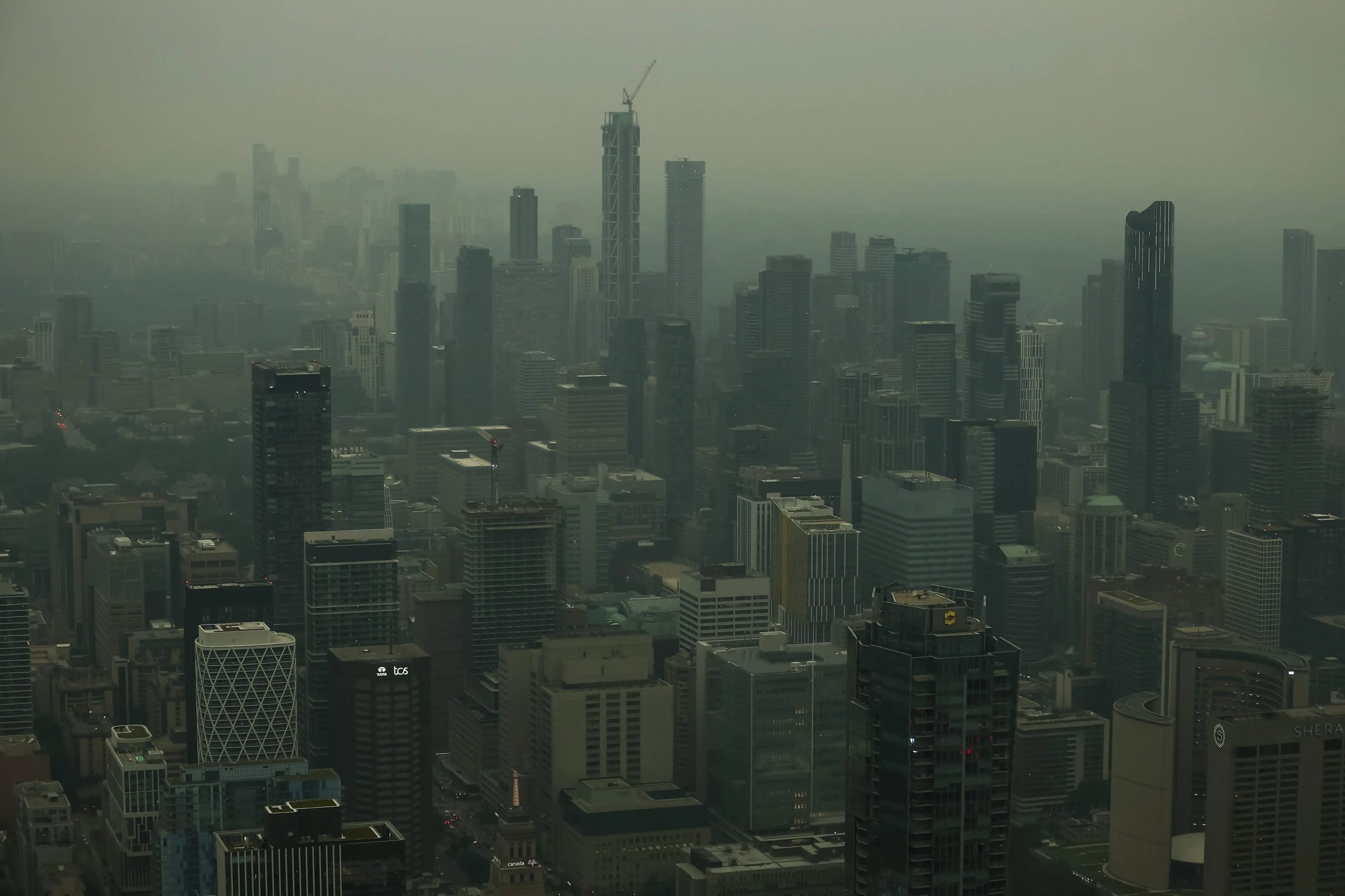 View of buildings from the CN Tower as smoke from wildfires in northern Ontario blankets the city, causing poor air quality, in Toronto, Ontario | AFP