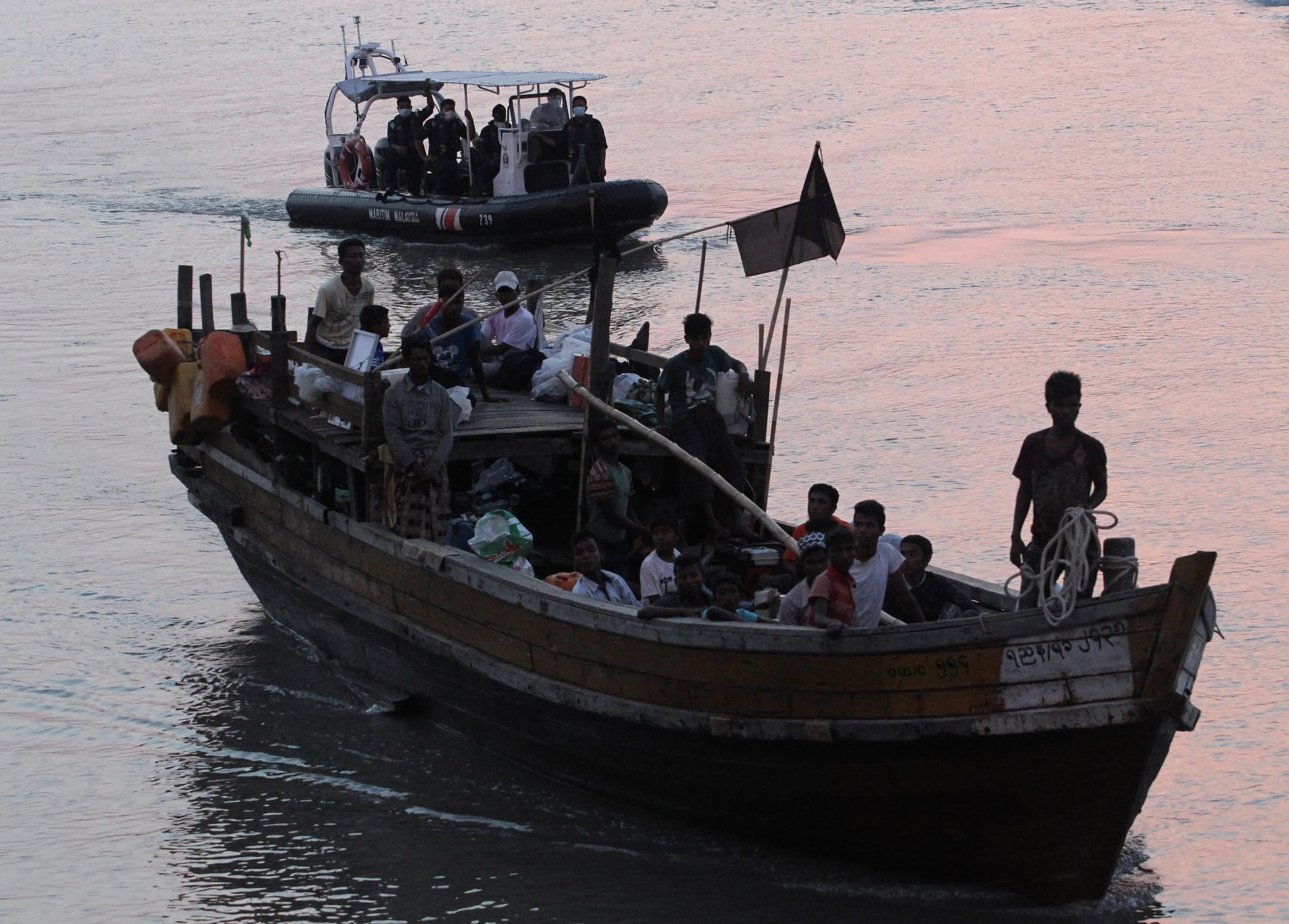 File photo | Rohingya refugees who were intercepted by Malaysian Maritime Enforcement Agency off Langkawi island, are escorted as they are handed over to immigration authorities, at the Kuala Kedah ferry jetty in Malaysia