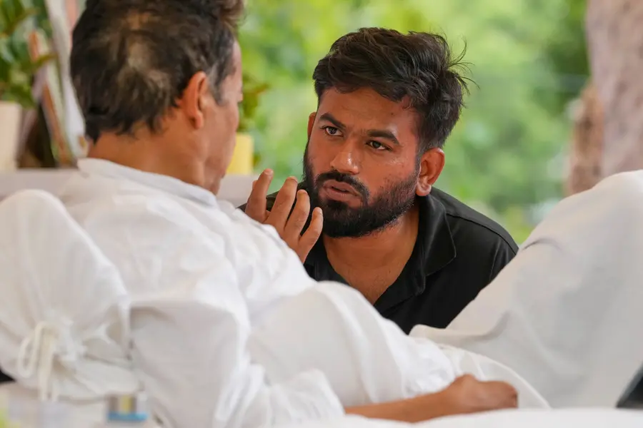 Abhijeet Dipke, founder of the Cockroach Janta Party, center, talks to climate activist Sonam Wangchuk