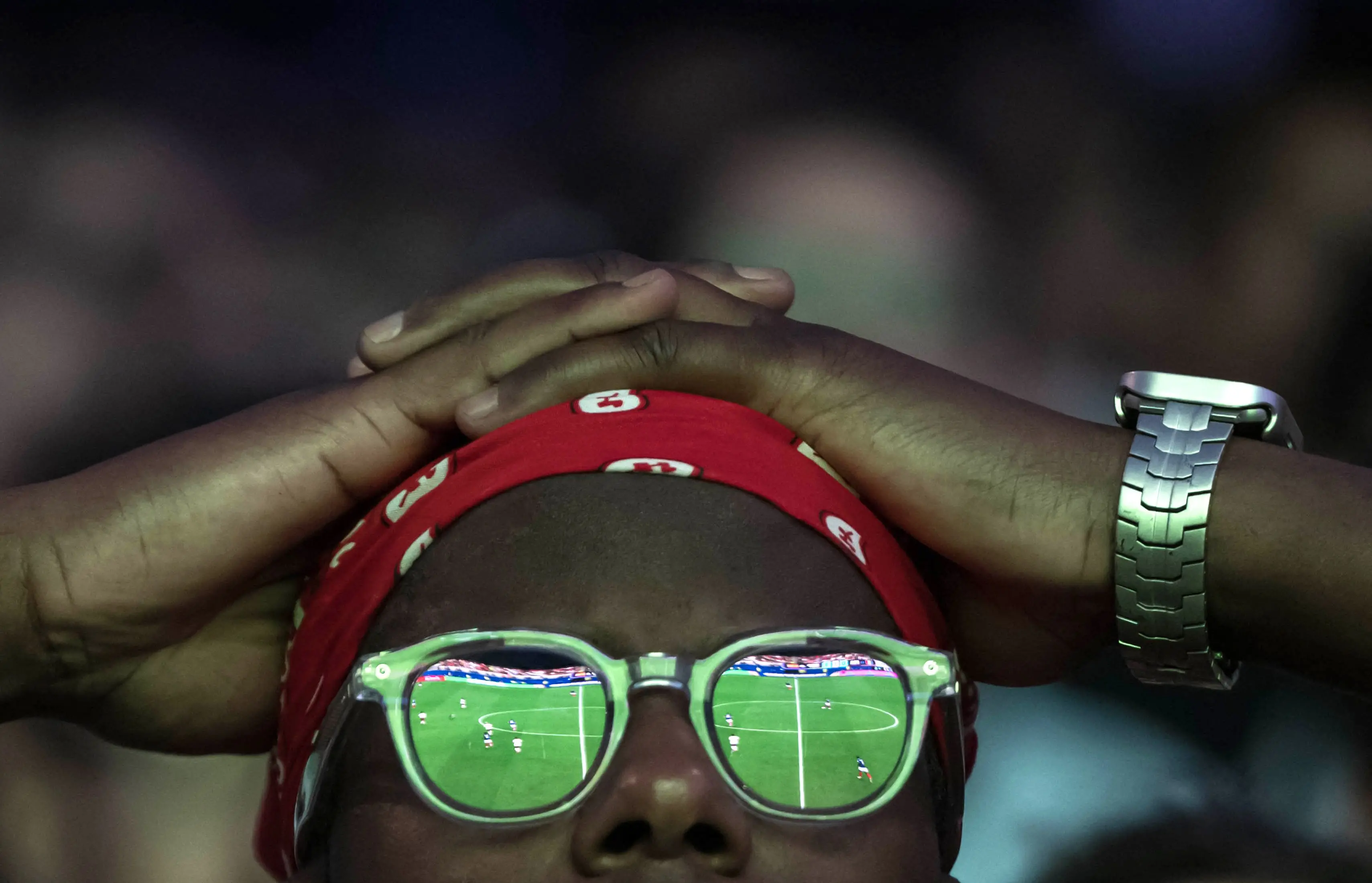 A supporter of France's football team watches the 2026 World Cup semi final football match between France and Spain/ AFP