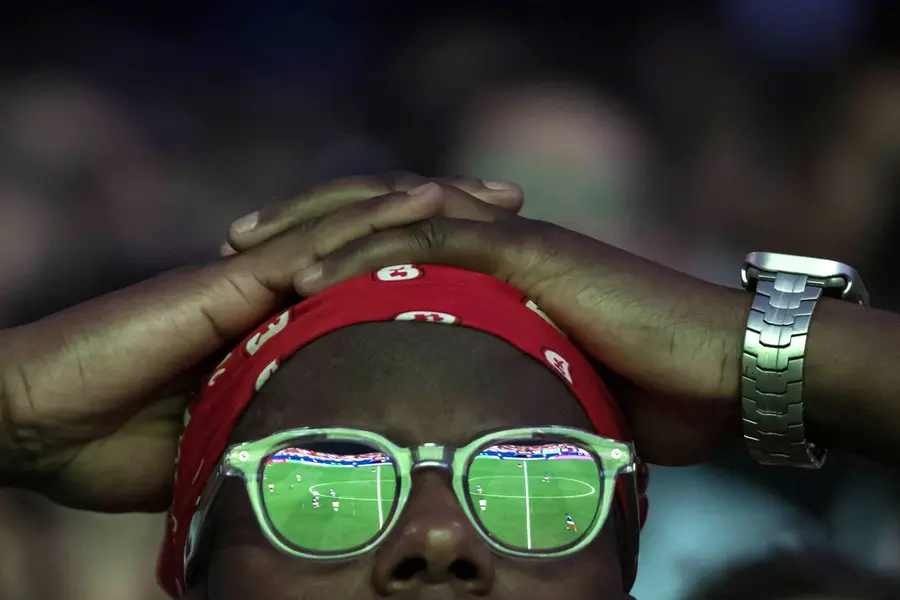 A supporter of France's football team watches the 2026 World Cup semi final football match between France and Spain/ AFP