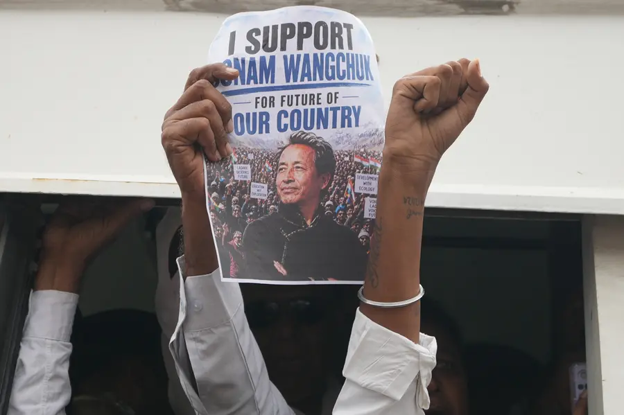 A protester holds a poster featuring educationist and activist Sonam Wangchuk