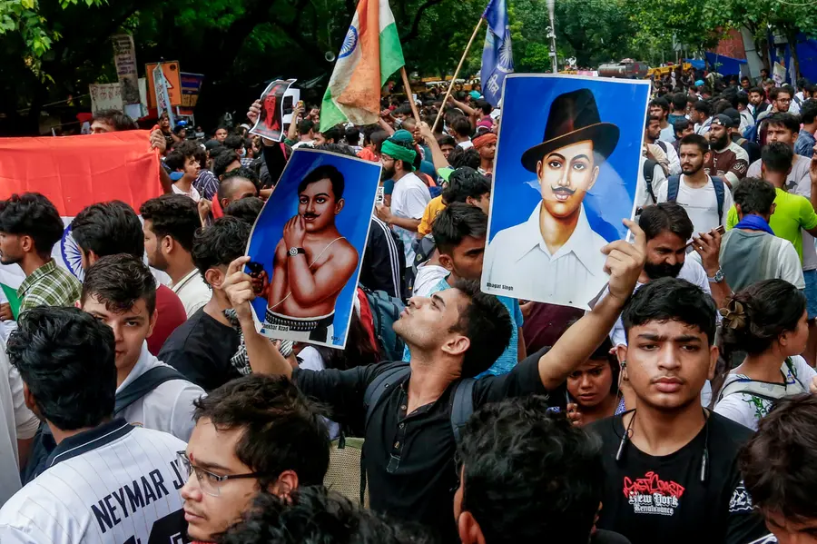 Cockroach Janata Party (CJP) supporters gather during a protest demanding the resignation of Union Education Minister Dharmendra Pradhan