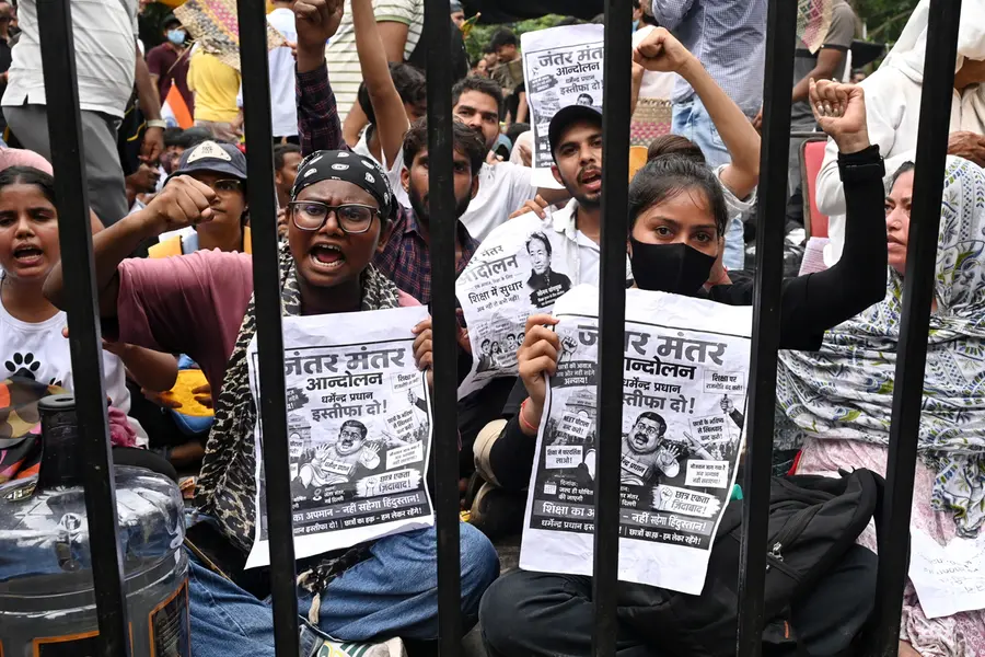 Protesters shout slogans as they carry posters asking for the resignation of Minister of Education Dharmendra Pradhan at a protest led by Cockroach Janta Party in New Delhi | AP