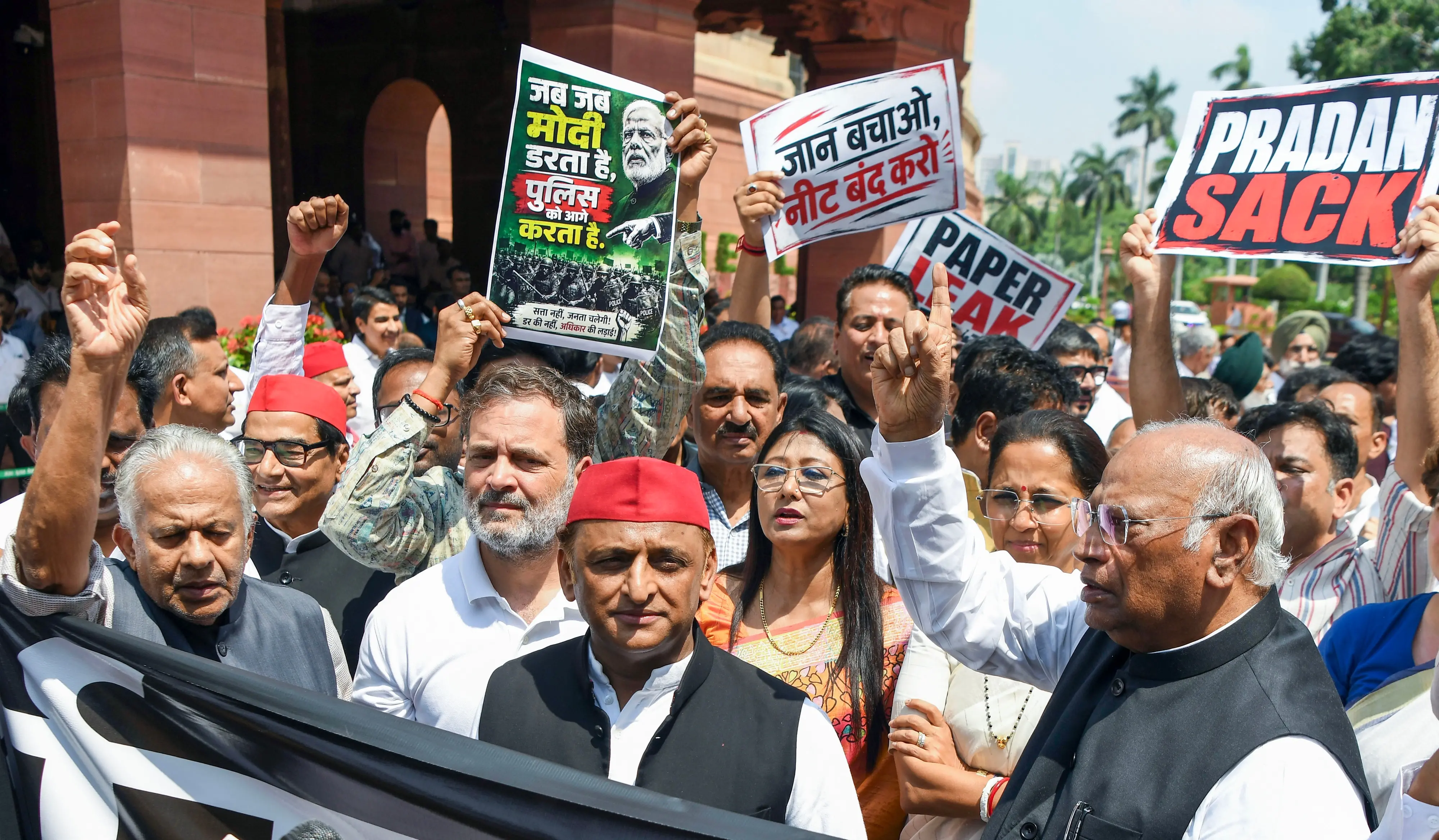 Rajya Sabha LoP and Congress President Mallikarjun Kharge, Lok Sabha LoP Rahul Gandhi and Samajwadi Party National President Akhilesh Yadav with other opposition MPs take part in protest against the NEET paper leak issue at the Parliament premises during the ongoing Monsoon Session, in New Delhi.| Photo: ANI