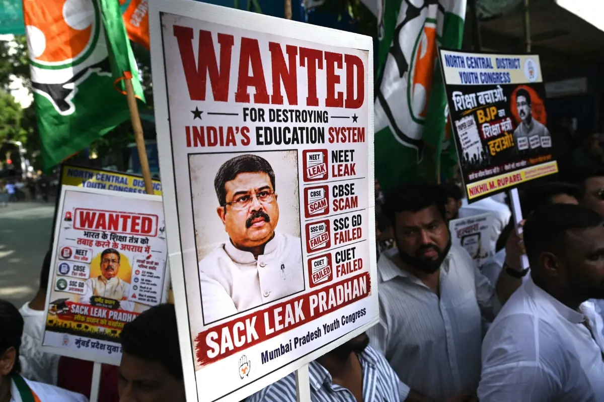Indian Youth Congress party workers hold placards of India's Education Minister Dharmendra Pradhan during a protest against National Testing Agency (NTA) over the alleged exam paper leak and subsequent rescheduling of National Eligibility-cum-Entrance Test (Undergraduate) (NEET-UG) in Mumbai.| Photo: AFP