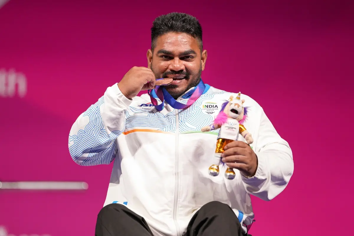 India's Jhandu Kumar celebrates after winning the bronze medal during the medal ceremony for the men's heavyweight para powerlifting event at the Commonwealth Games 2026, in Glasgow | Photo: PTI