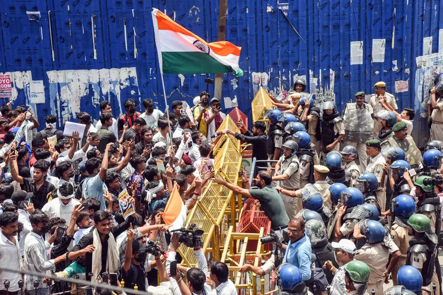 Police personnel try to stop youths during a ‘Bharat Bandh’ protest demanding the resignation of Union Education Minister Dharmendra Pradhan