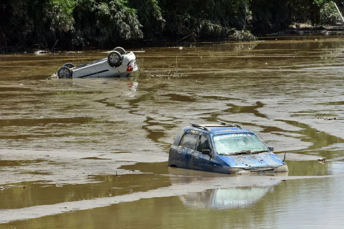A view of a damaged car, which swept away in a flash flood of the Dikhow River at Bihubar, in Sivasagar on Saturday. (ANI Photo)
