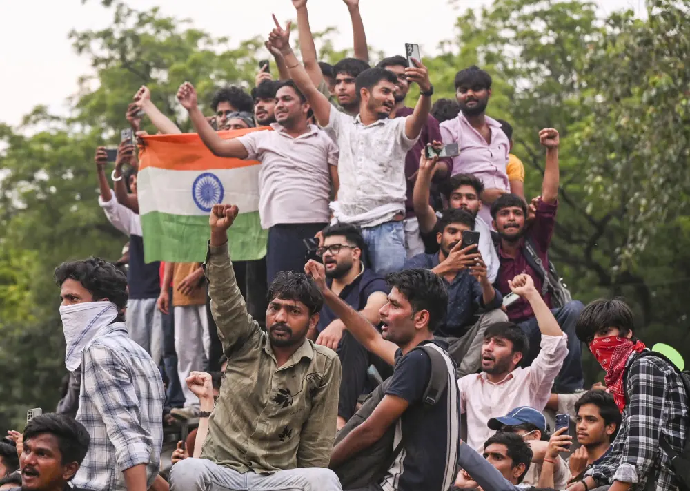 Cockroach Janta Party supporters celebrate after Union Education Minister Dharmendra Pradhan resigned and took responsibility for the NEET paper leak | PTI