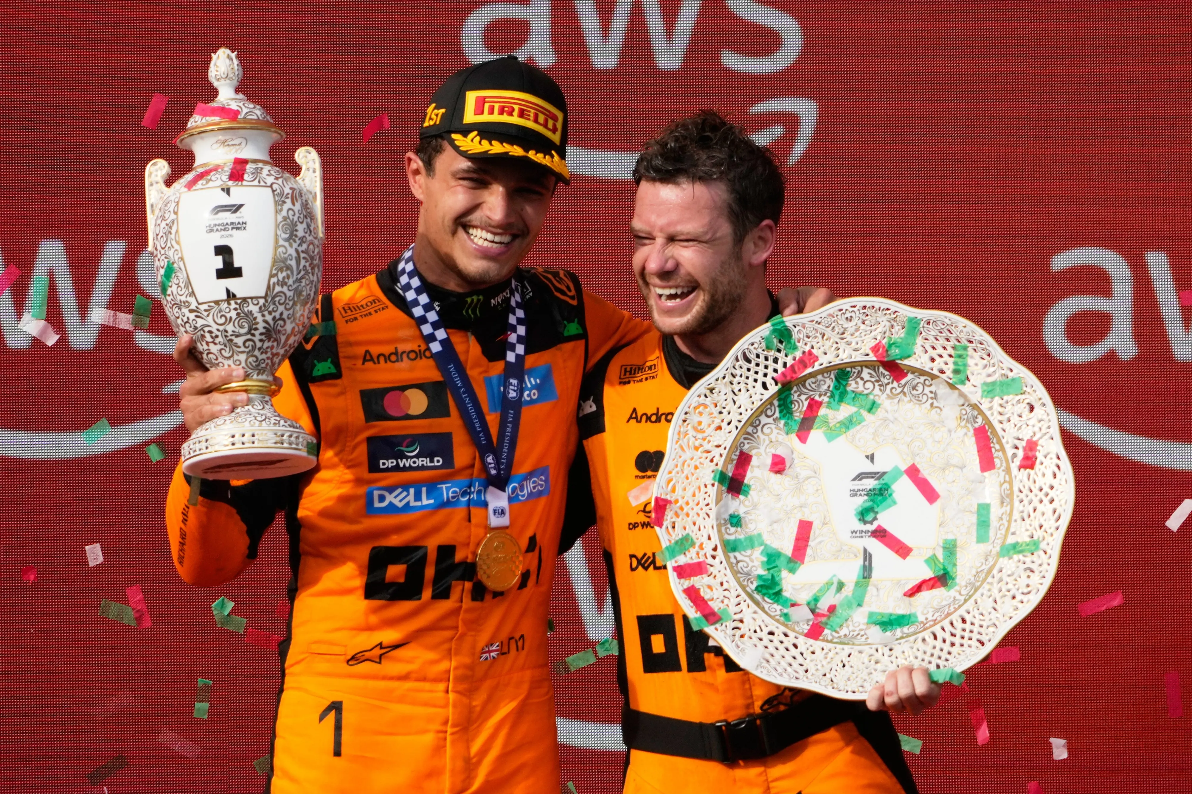 McLaren driver Lando Norris of Britain celebrates with teammate after winning the Formula One Hungarian Grand Prix auto race, at the Hungaroring racetrack in Mogyorod, near Budapest, Hungary.| Photo: AP
