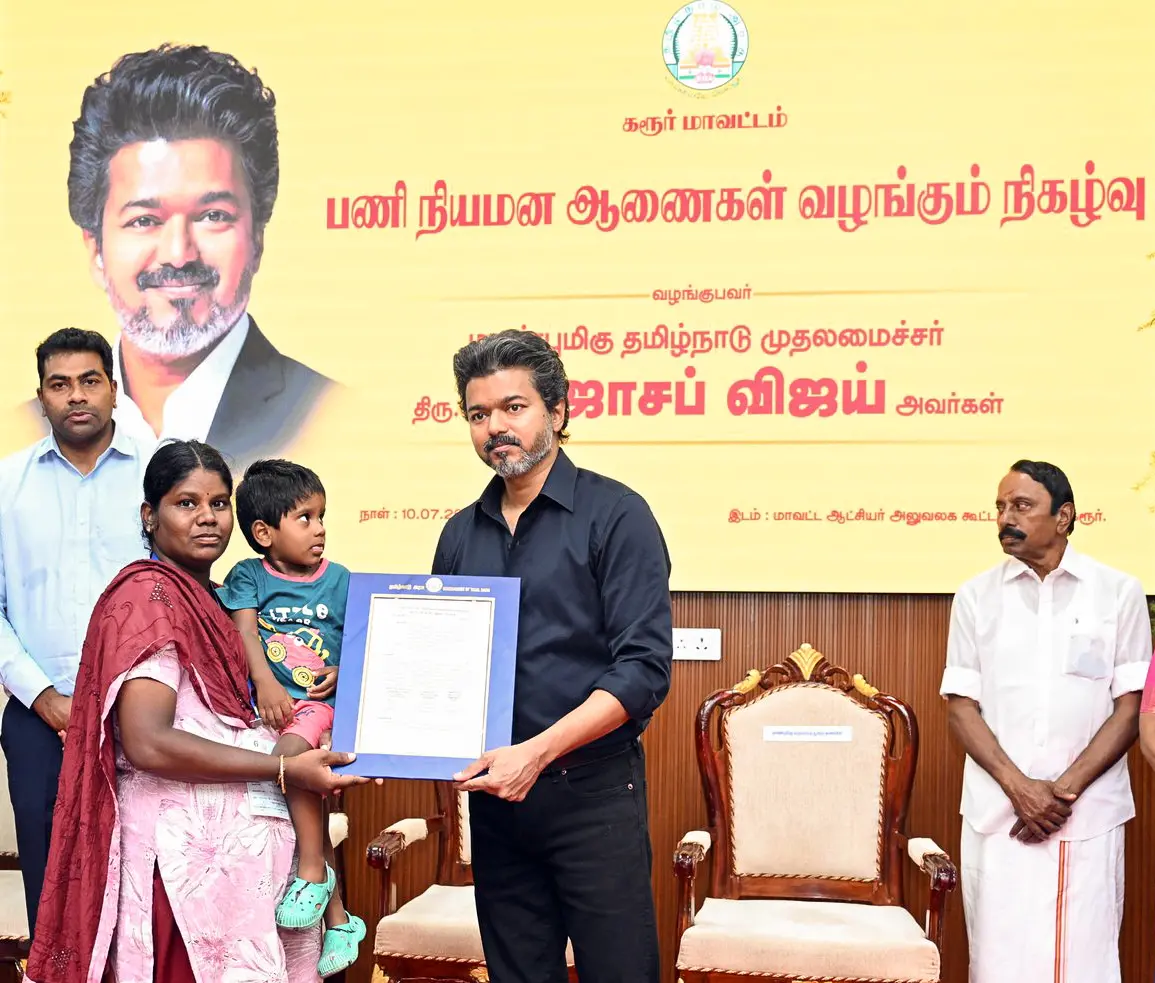 Tamil Nadu CM S. Joseph Vijay hands over an appointment order on compassionate grounds to a legal heir of an individual