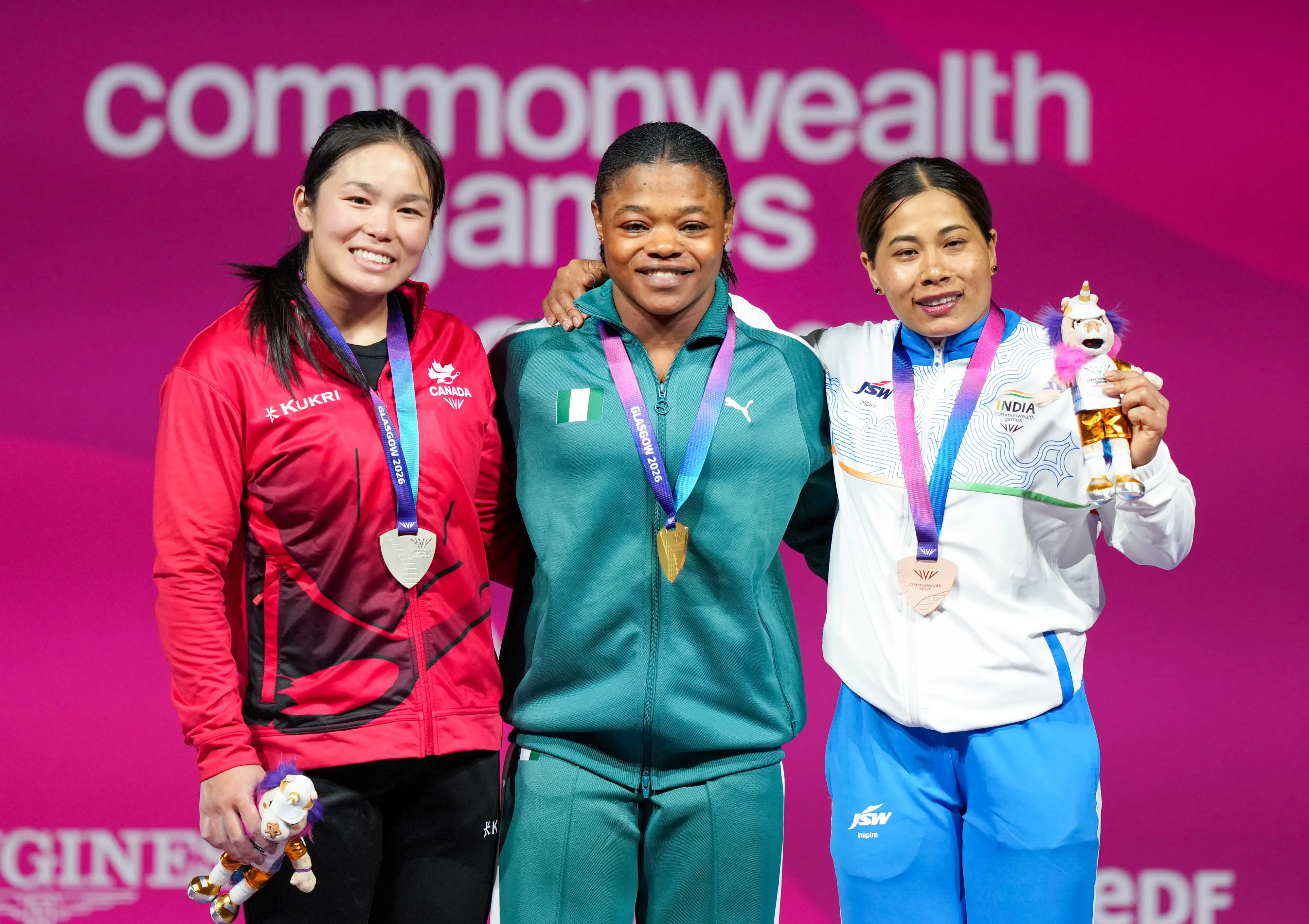 Gold medallist Rafiatu Folashade Lawal of Nigeria, centre, silver medallist Ann Sophie Taschereau of Canada, left, and bronze medallist Bindyarani Devi of India pose during the medal ceremony for the Women's 58kg weightlifting event at the Commonwealth Games 2026, in Glasgow, Scotland