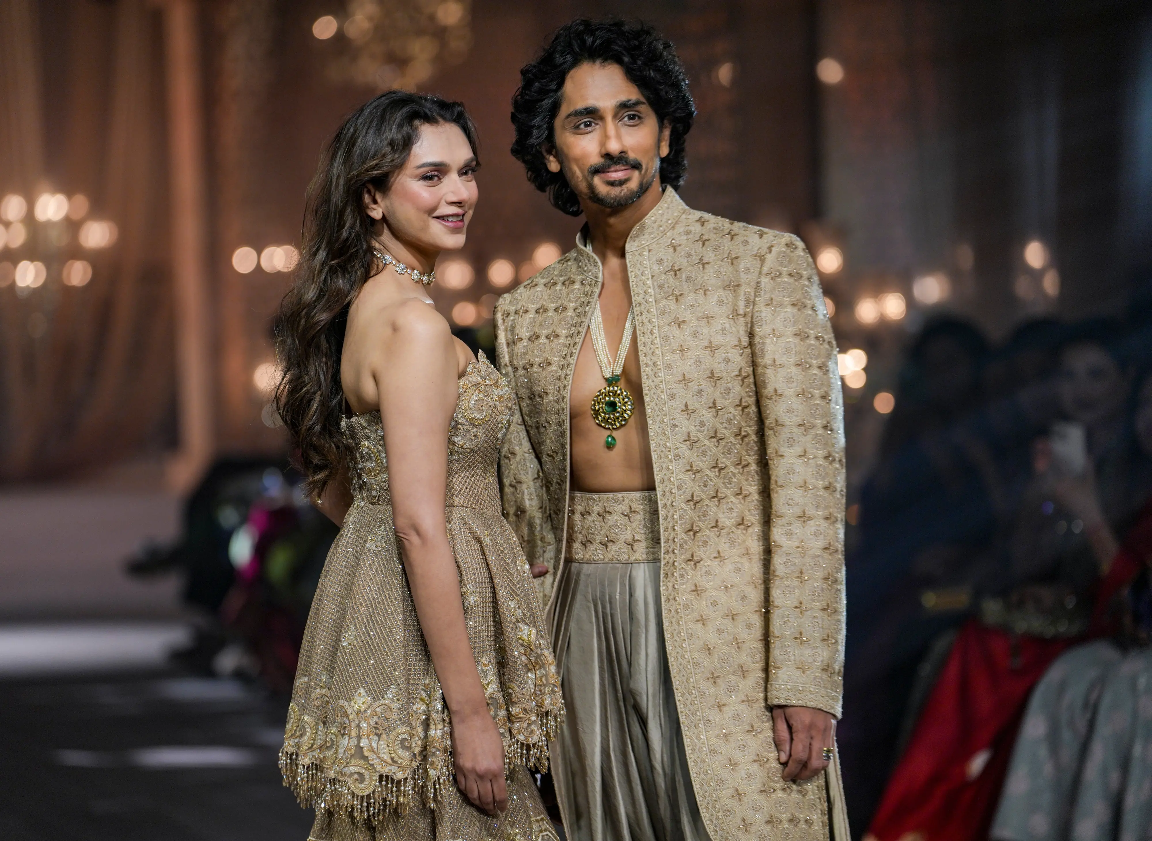 Bollywood actor Aditi Rao Hydari, the showstopper, walks the ramp with her husband Siddharth during the presentation of designer Jayanti Reddy's collection at India Couture Week 2026 | PTI