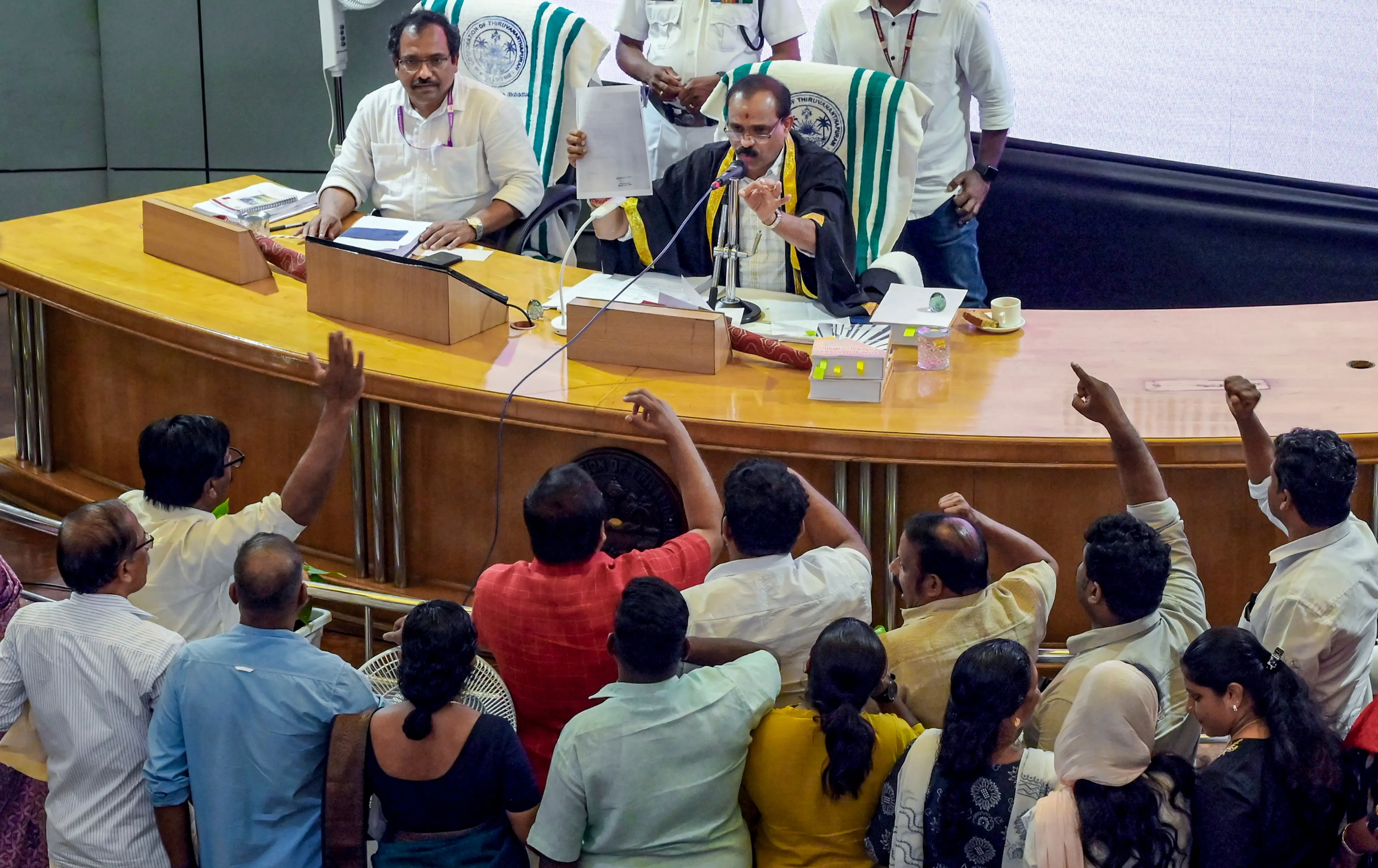 Opposition councillors staging a protest during a Thiruvananthapuram Corporation council meeting after the BJP-led administration granted six months' leave to BJP councillor R Sugathan, who is lodged in Viyyur Central Jail under the Kerala Anti-Social Activities (Prevention) Act |  Photo: PTI